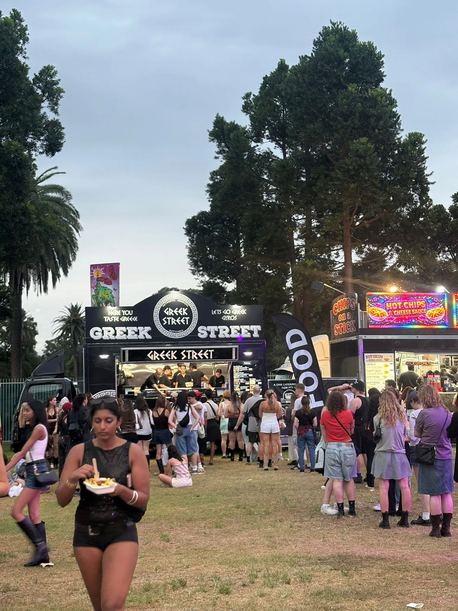 Night-time crowds queueing for food at a busy outdoor event
